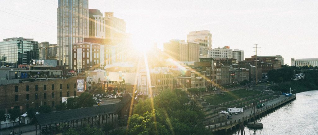 city with sun breaking through the buildings